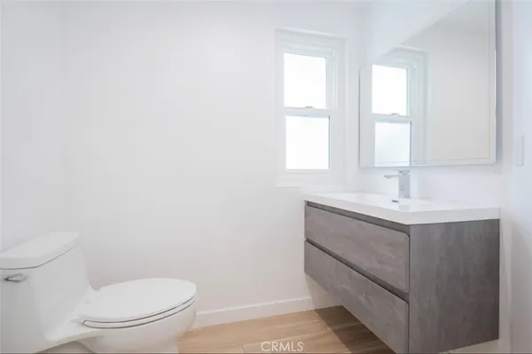 a bathroom with a sink a toilet and window