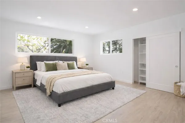 a bedroom with a large bed and a window