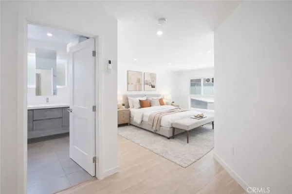 an empty room with cabinet and mirrors