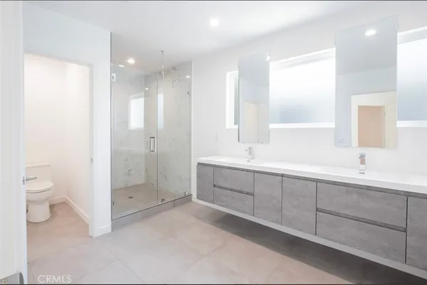 a bathroom with a walk in closet and mirror