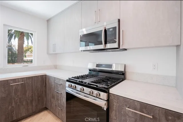 a kitchen with stainless steel appliances a sink and a stove