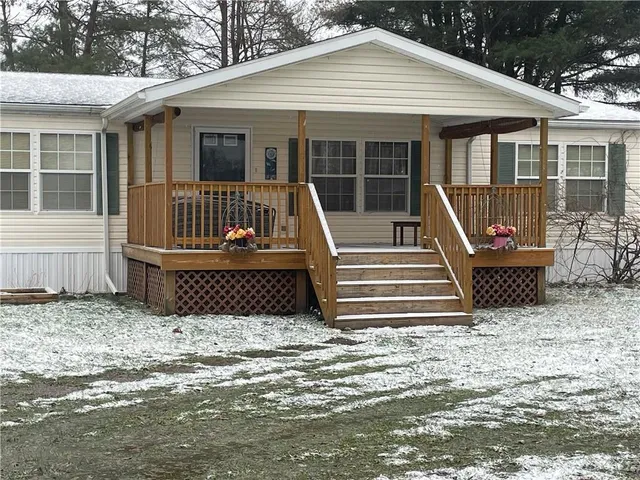 a view of a house with wooden floor and a yard