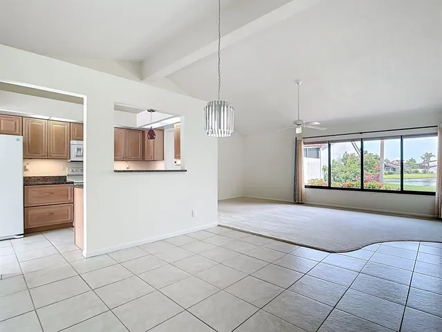 a kitchen with granite countertop a sink and cabinets