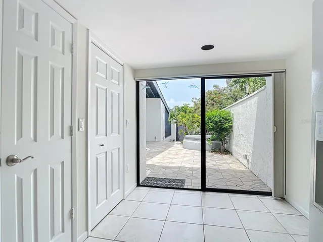 a kitchen with granite countertop a refrigerator and a sink