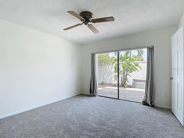 an empty room with a ceiling fan