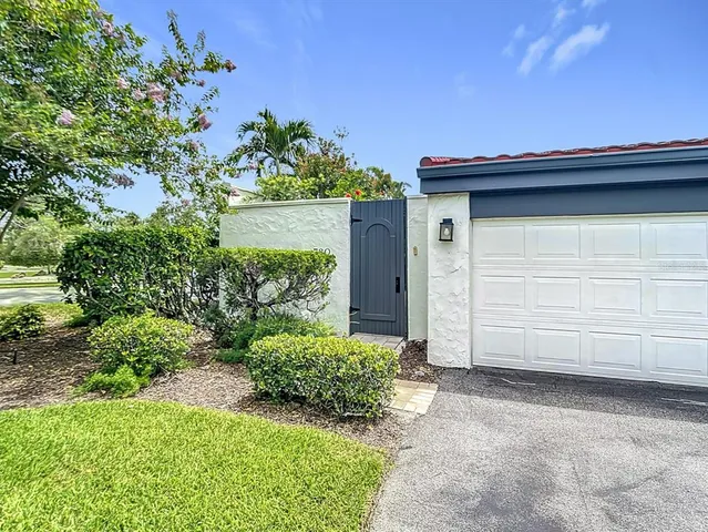 a front view of a house with a yard and a garden