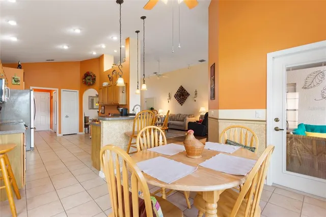 a kitchen with stainless steel appliances granite countertop a refrigerator a stove and a wooden cabinets