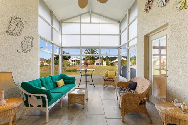 a living room with furniture a rug and white walls