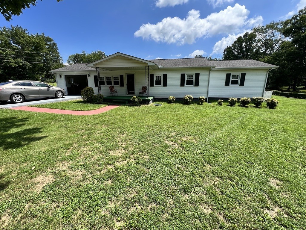 890 Hobbs Hill Road Tracy City, TN 37387 - Photo 17 of 31 a front view of a house with a garden