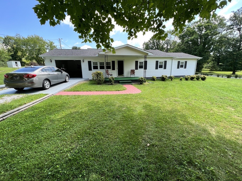 890 Hobbs Hill Road Tracy City, TN 37387 - Photo 2 of 31 a front view of a house with a garden