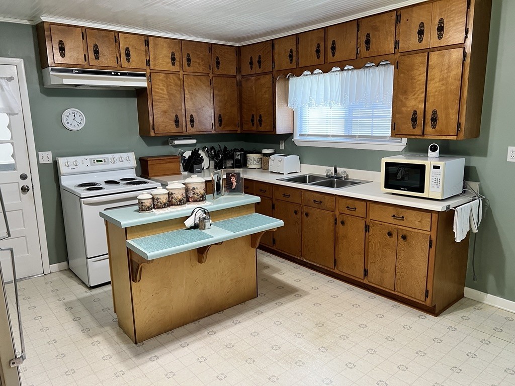 890 Hobbs Hill Road Tracy City, TN 37387 - Photo 6 of 31 a kitchen with stainless steel appliances granite countertop a sink stove and cabinets