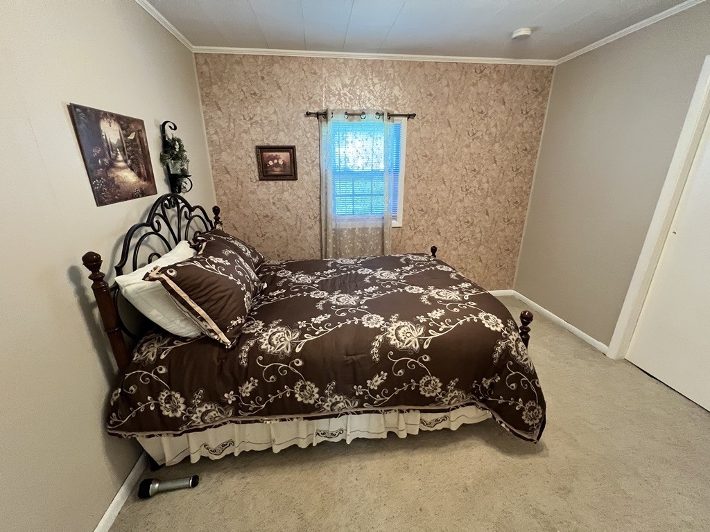 890 Hobbs Hill Road Tracy City, TN 37387 - Photo 8 of 31 a bed sitting in a room next to a window