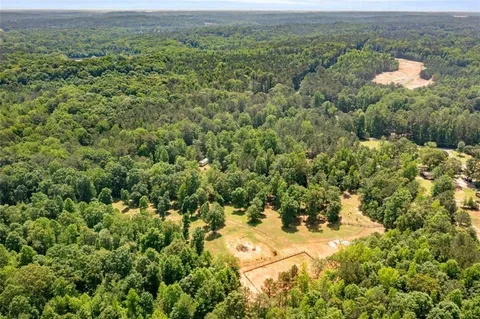 a backyard of a house with a yard and large trees