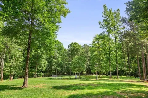a view of field with trees in the background