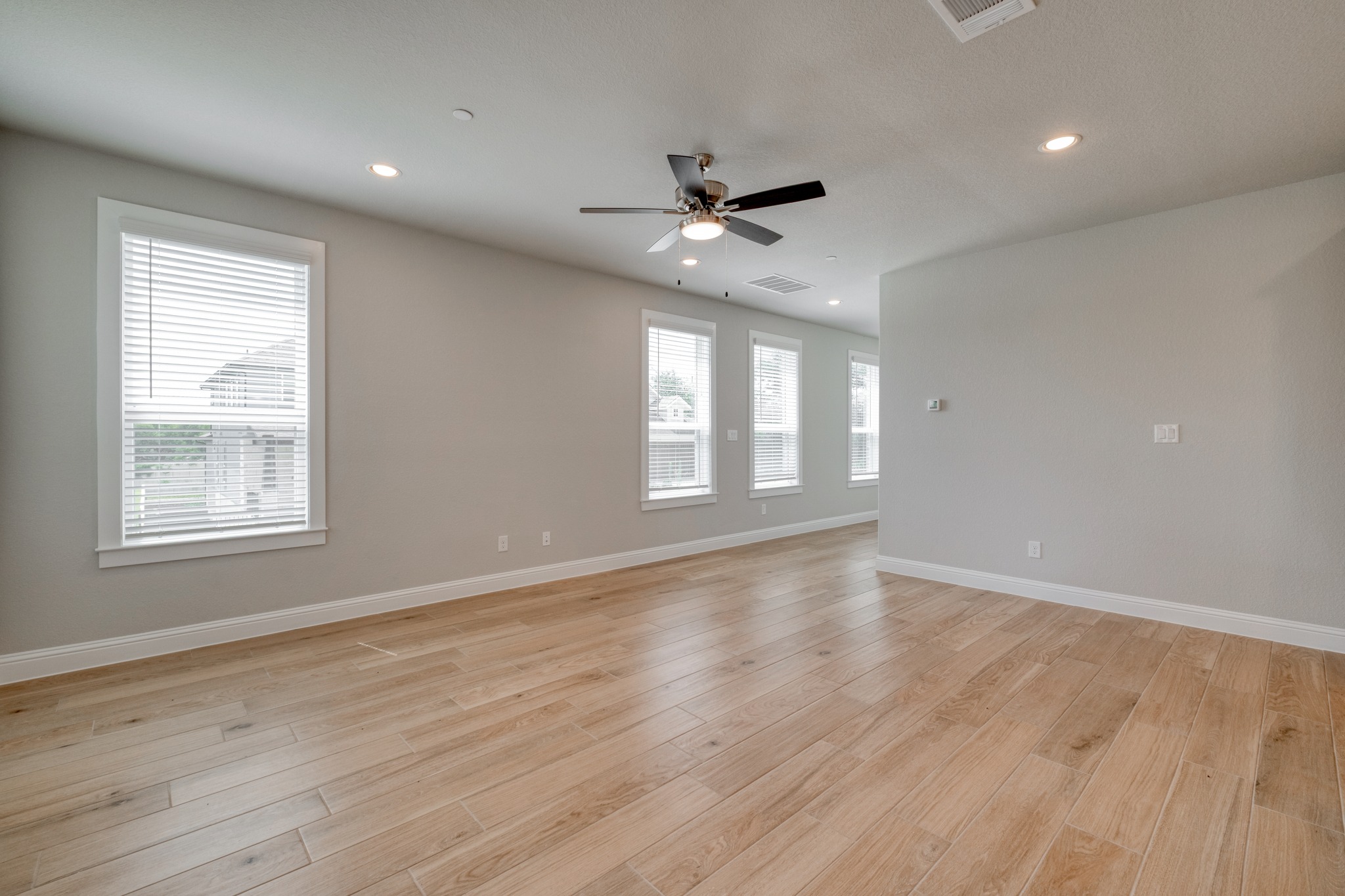 2605 Sam Bass Road, Unit 44 Round Rock, TX 78681 - Photo 7 of 26 The ample living area provides durable flooring and several windows for natural light.