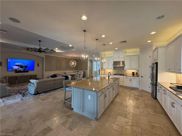 a large kitchen with stainless steel appliances lots of counter top space