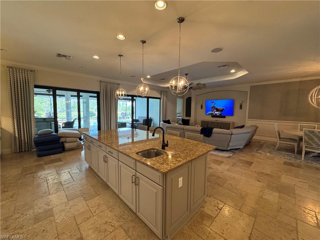 9470 Galliano Terrace Naples, FL 34119 - Photo 12 of 49 a living room with furniture a flat screen tv and a large window