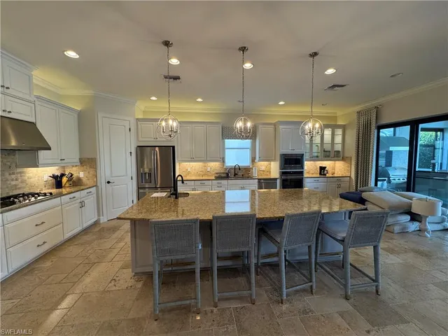 a large kitchen with a table and chairs