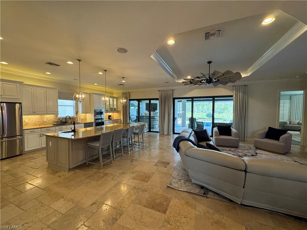 9470 Galliano Terrace Naples, FL 34119 - Photo 17 of 49 a living room with lots of furniture and kitchen view