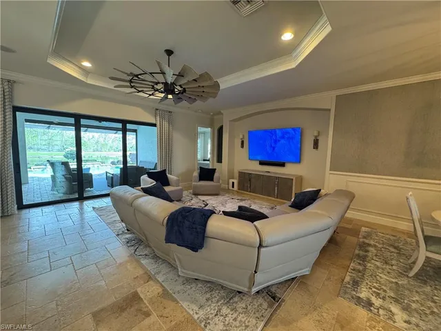 a living room with furniture a large window with walls