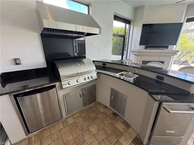 a kitchen with white cabinets and black appliances