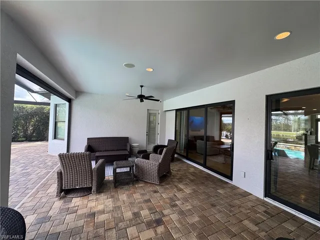a living room with furniture and large windows