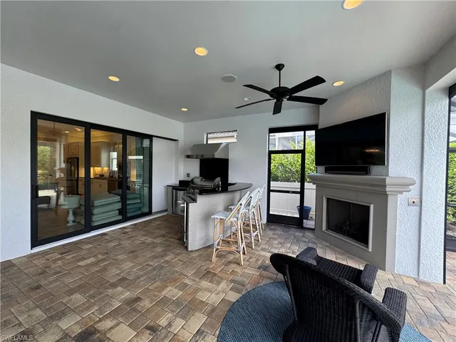 a living room with a couch a flat screen tv and a fireplace