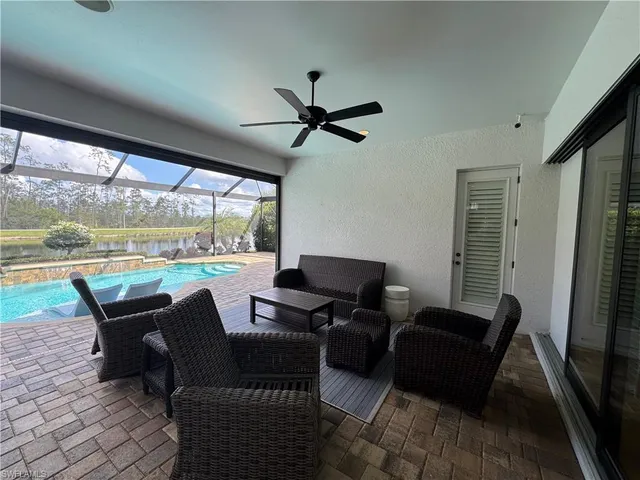 a living room with patio furniture and a flat screen tv
