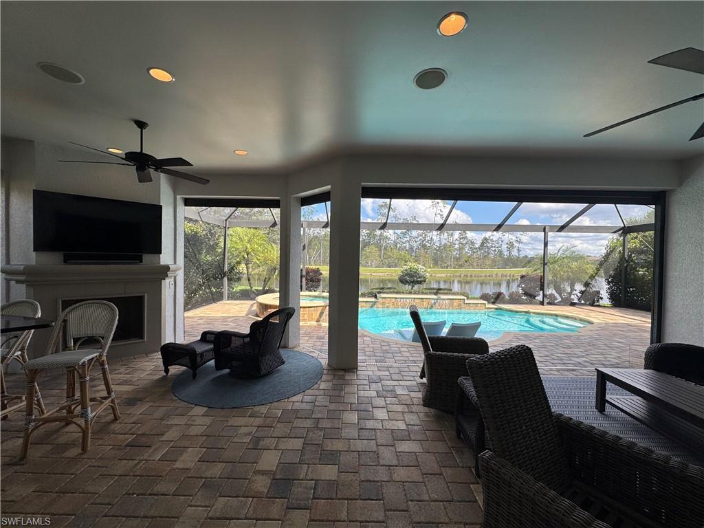 9470 Galliano Terrace Naples, FL 34119 - Photo 27 of 49 a living room with patio furniture and a flat screen tv