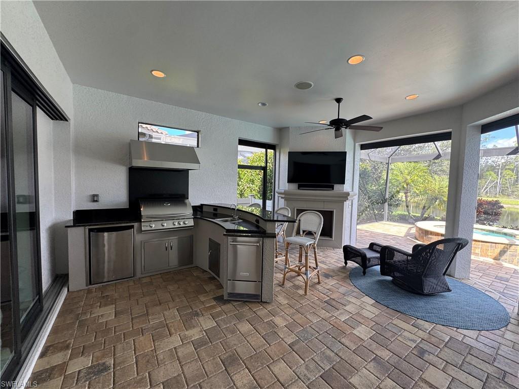 9470 Galliano Terrace Naples, FL 34119 - Photo 28 of 49 a large kitchen with stainless steel appliances a stove a sink dishwasher a dining table and chair with the large window