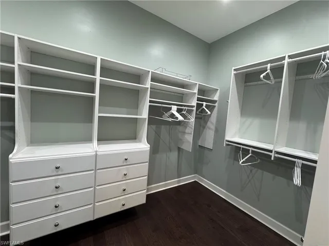 a large bathroom with a large mirror vanity and shower