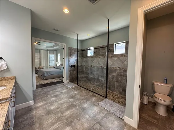 a large bathroom with a large mirror vanity and shower