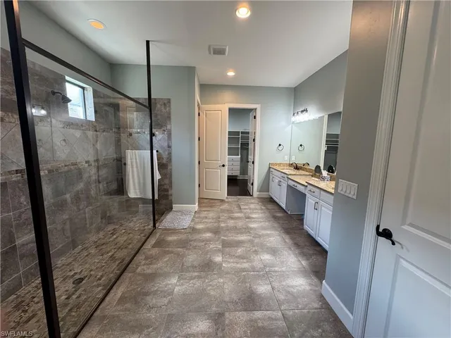 a bedroom with a large bed and a couch