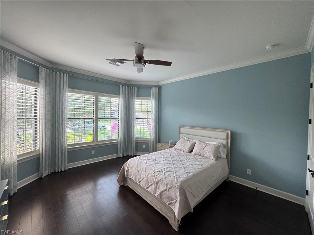 9470 Galliano Terrace Naples, FL 34119 - Photo 39 of 49 a bedroom with a large bed and a large window