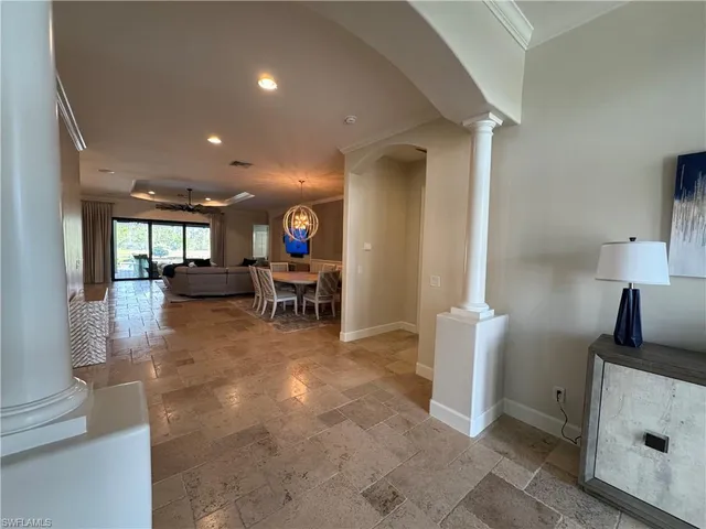 a lobby with furniture and floor to ceiling window