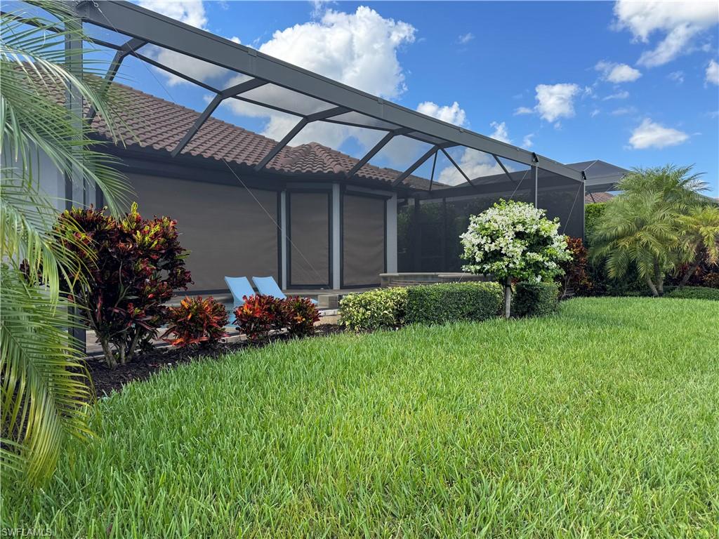 9470 Galliano Terrace Naples, FL 34119 - Photo 46 of 49 a view of a house with backyard and garden