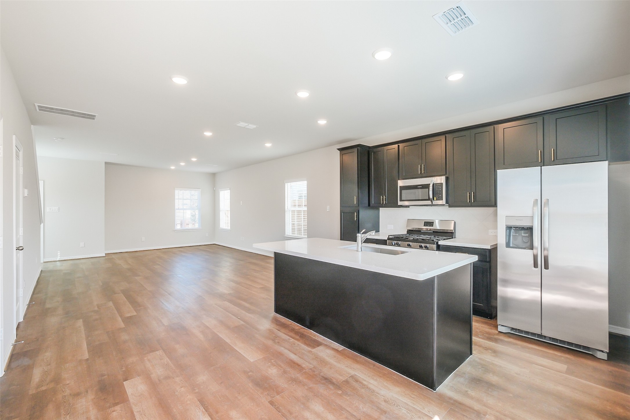 6407 Paris Street Houston, TX 77021 - Photo 12 of 31 a kitchen with stainless steel appliances a refrigerator and a stove top oven