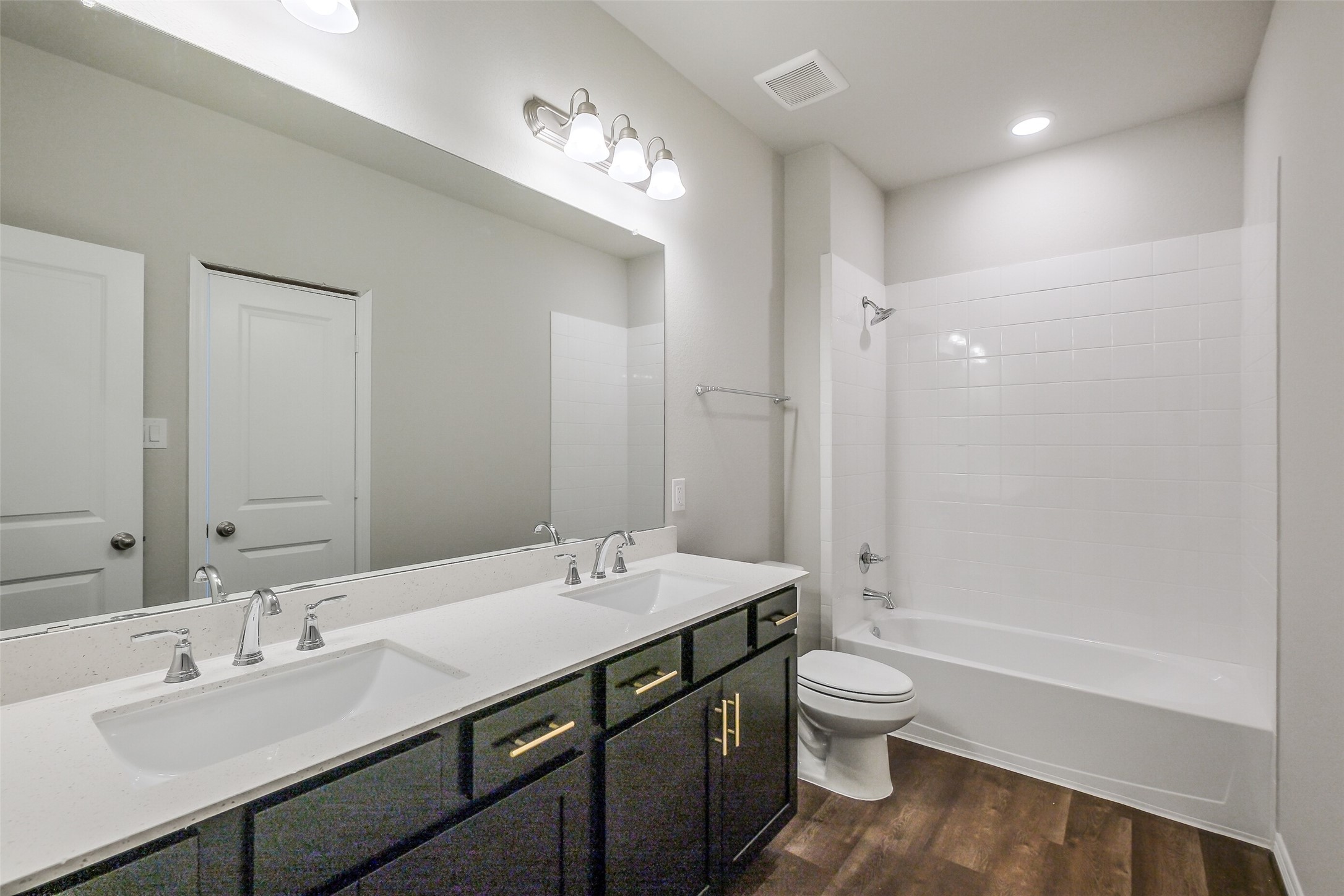6407 Paris Street Houston, TX 77021 - Photo 20 of 31 a bathroom with a double vanity sink toilet mirror and shower
