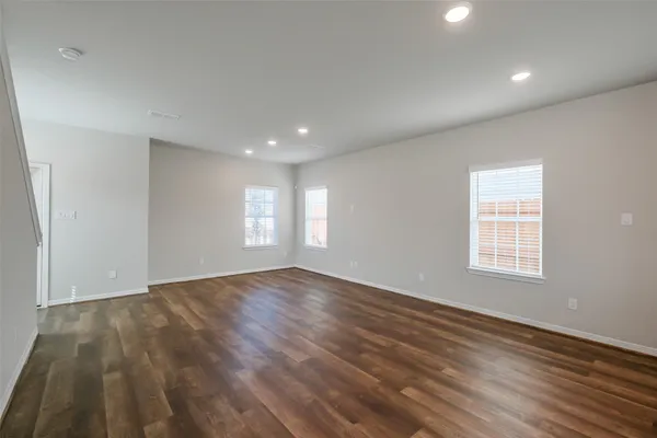 a view of kitchen with kitchen island wooden floor wooden floor and window
