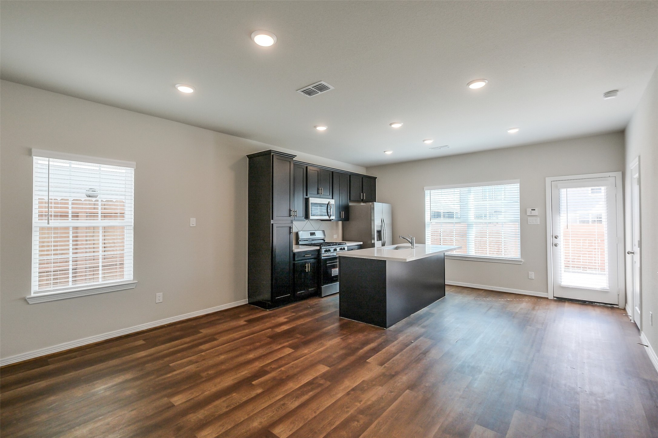 6407 Paris Street Houston, TX 77021 - Photo 10 of 31 a view of kitchen with kitchen island wooden floor wooden floor and window