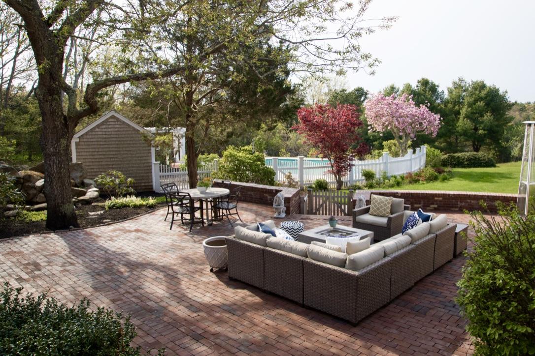 14 Ice Valley Road Osterville, MA 02655 - Photo 16 of 35 a view of a patio with couches and a table and chairs with garden view