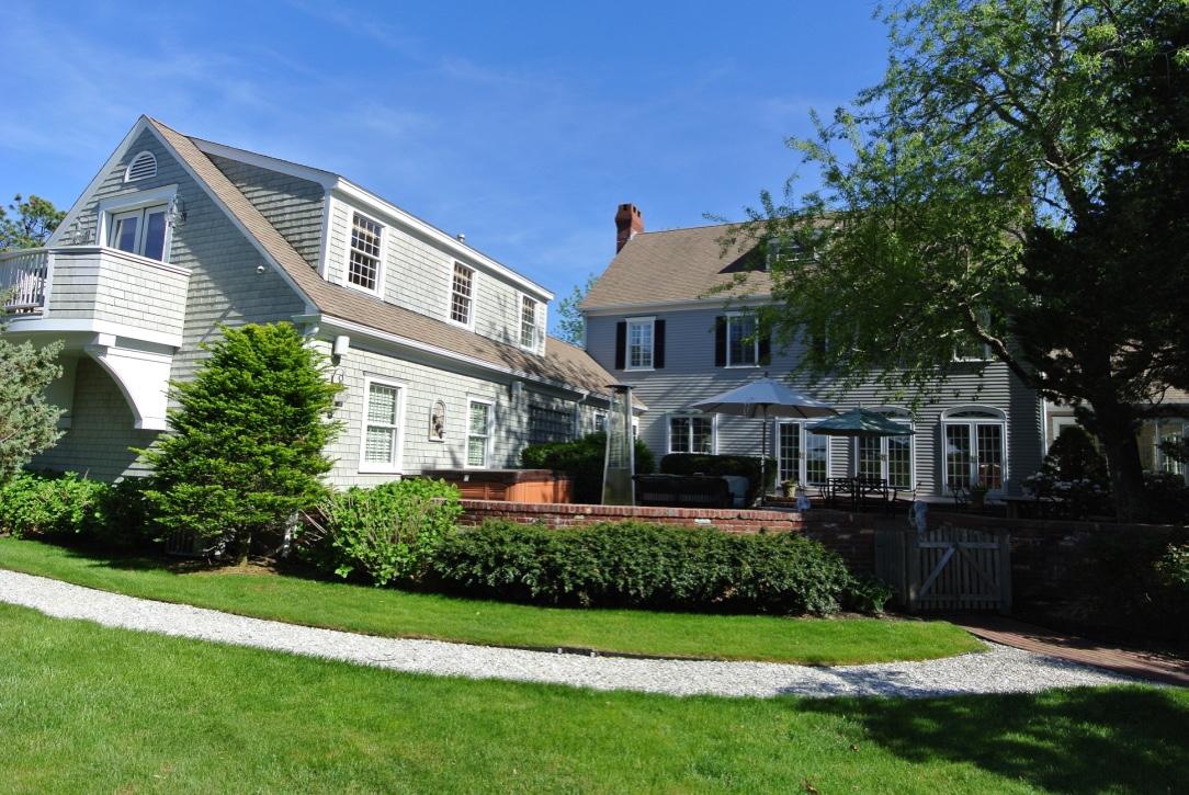 14 Ice Valley Road Osterville, MA 02655 - Photo 4 of 35 a front view of a house with a yard and potted plants