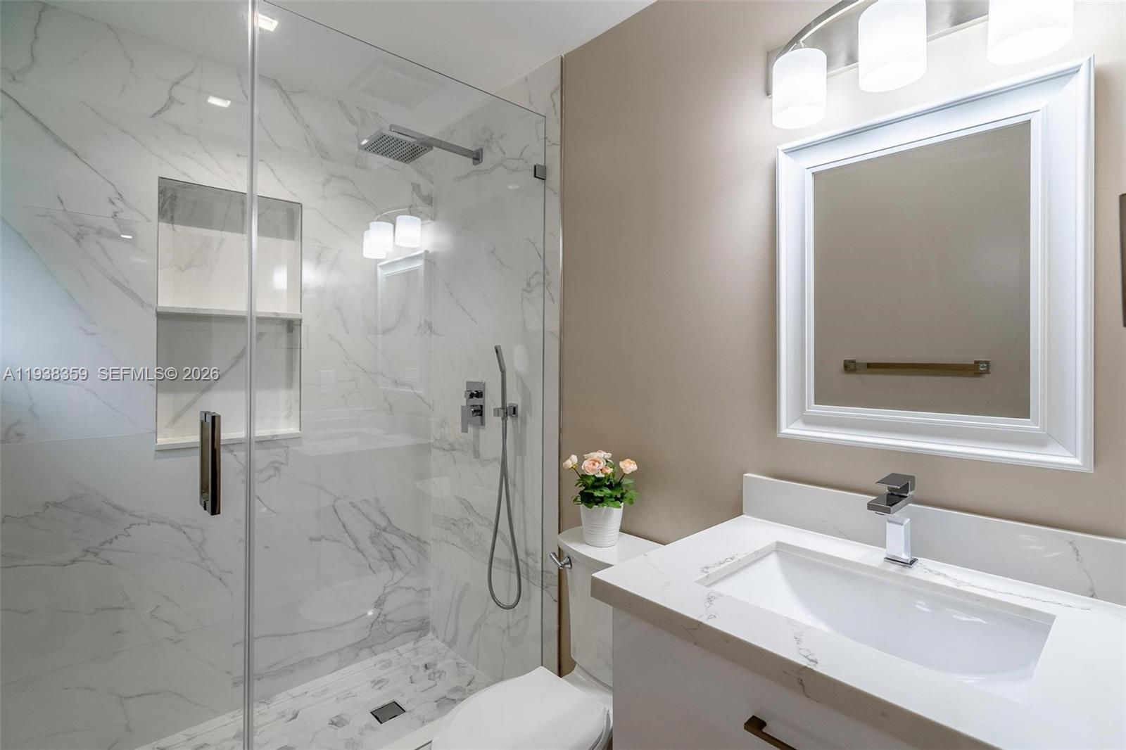 20221 Southwest 318th Street Homestead, FL 33030 - Photo 14 of 37 a bathroom with a sink toilet a mirror and shower