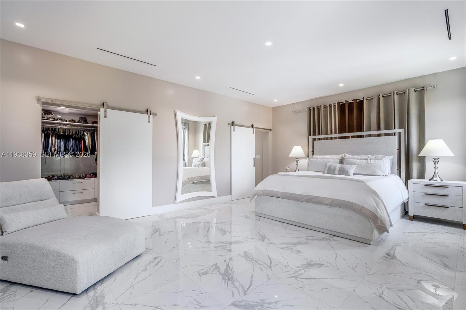 20221 Southwest 318th Street Homestead, FL 33030 - Photo 20 of 37 a spacious bedroom with a bed a couch and cabinet