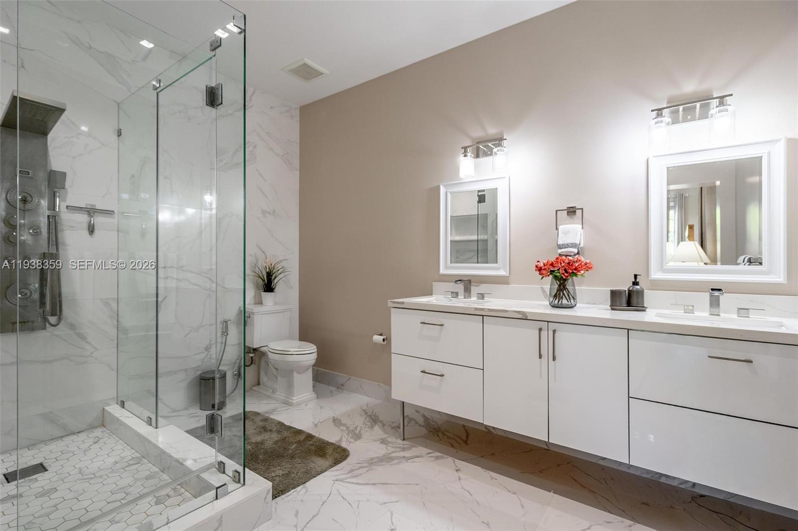 20221 Southwest 318th Street Homestead, FL 33030 - Photo 23 of 37 a spacious bathroom with a double vanity sink toilet and shower