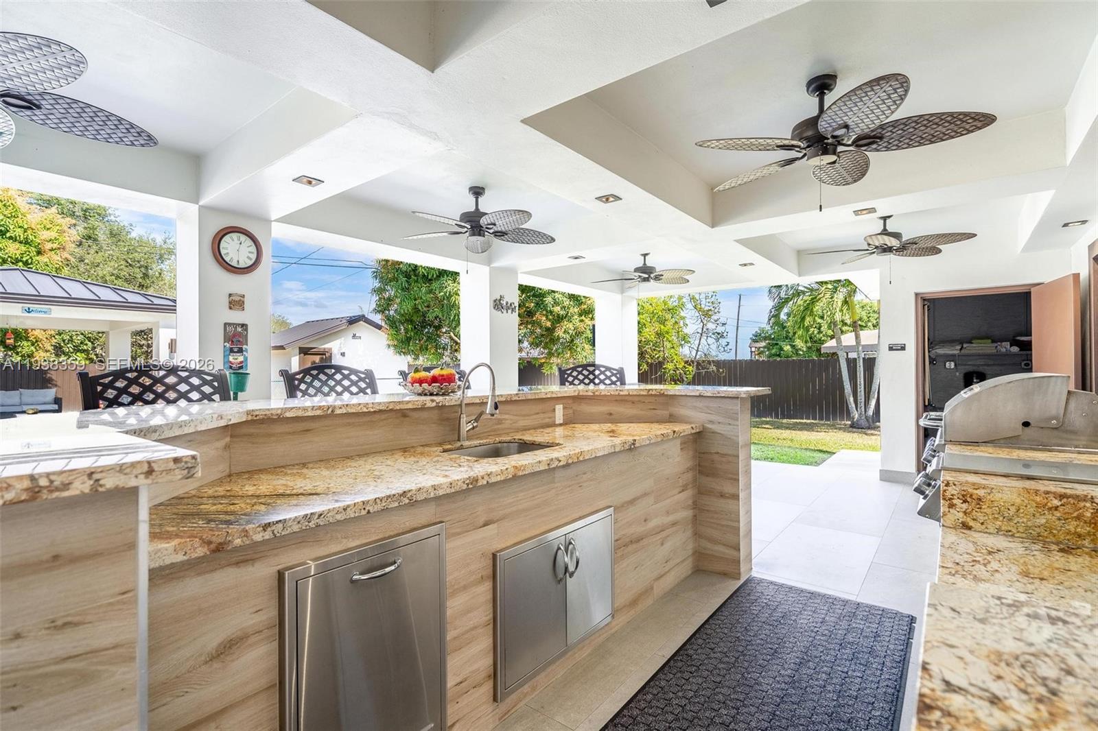 20221 Southwest 318th Street Homestead, FL 33030 - Photo 28 of 37 a kitchen with stainless steel appliances granite countertop a sink and a large window