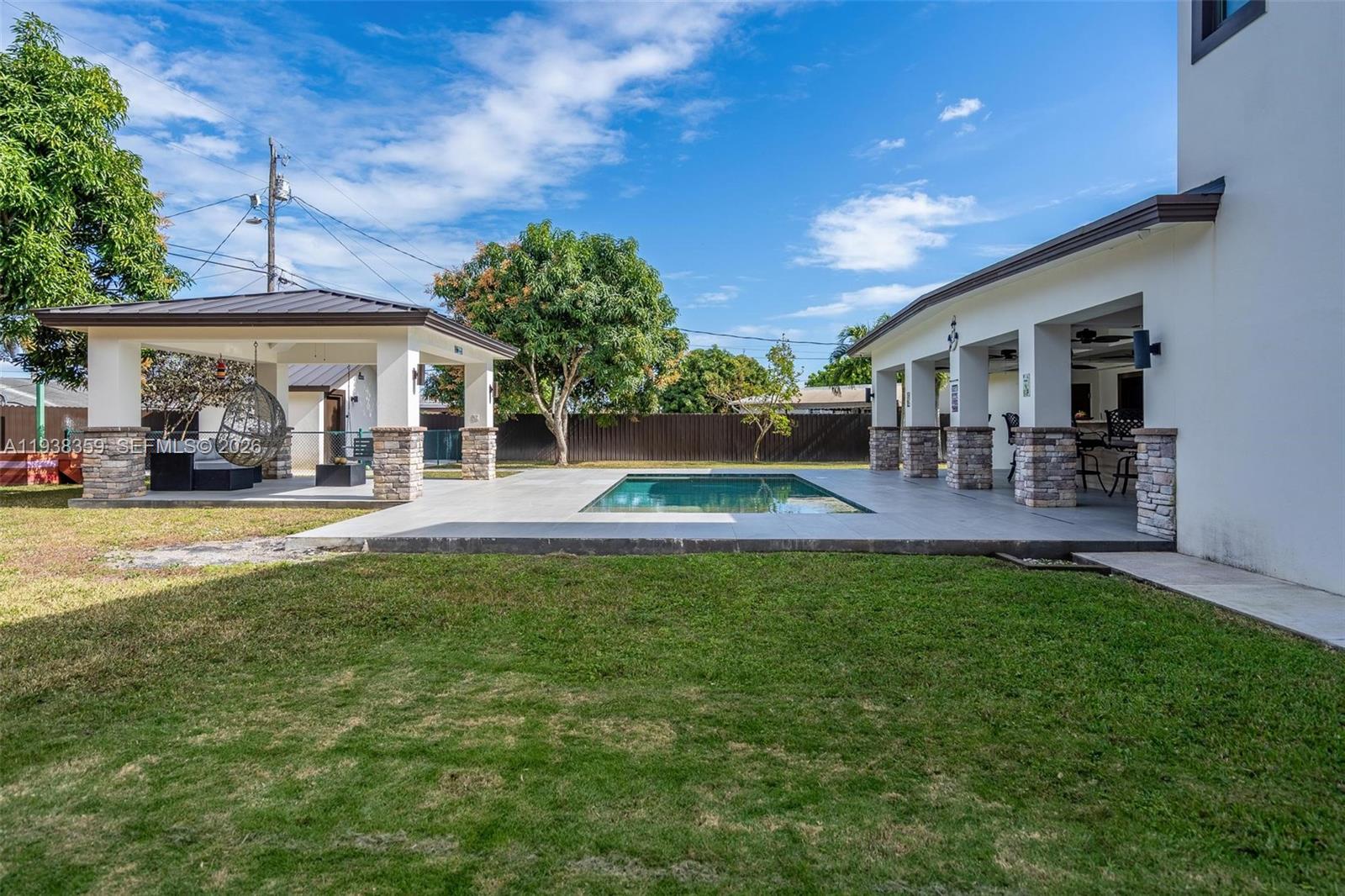 20221 Southwest 318th Street Homestead, FL 33030 - Photo 31 of 37 a front view of a house with a patio