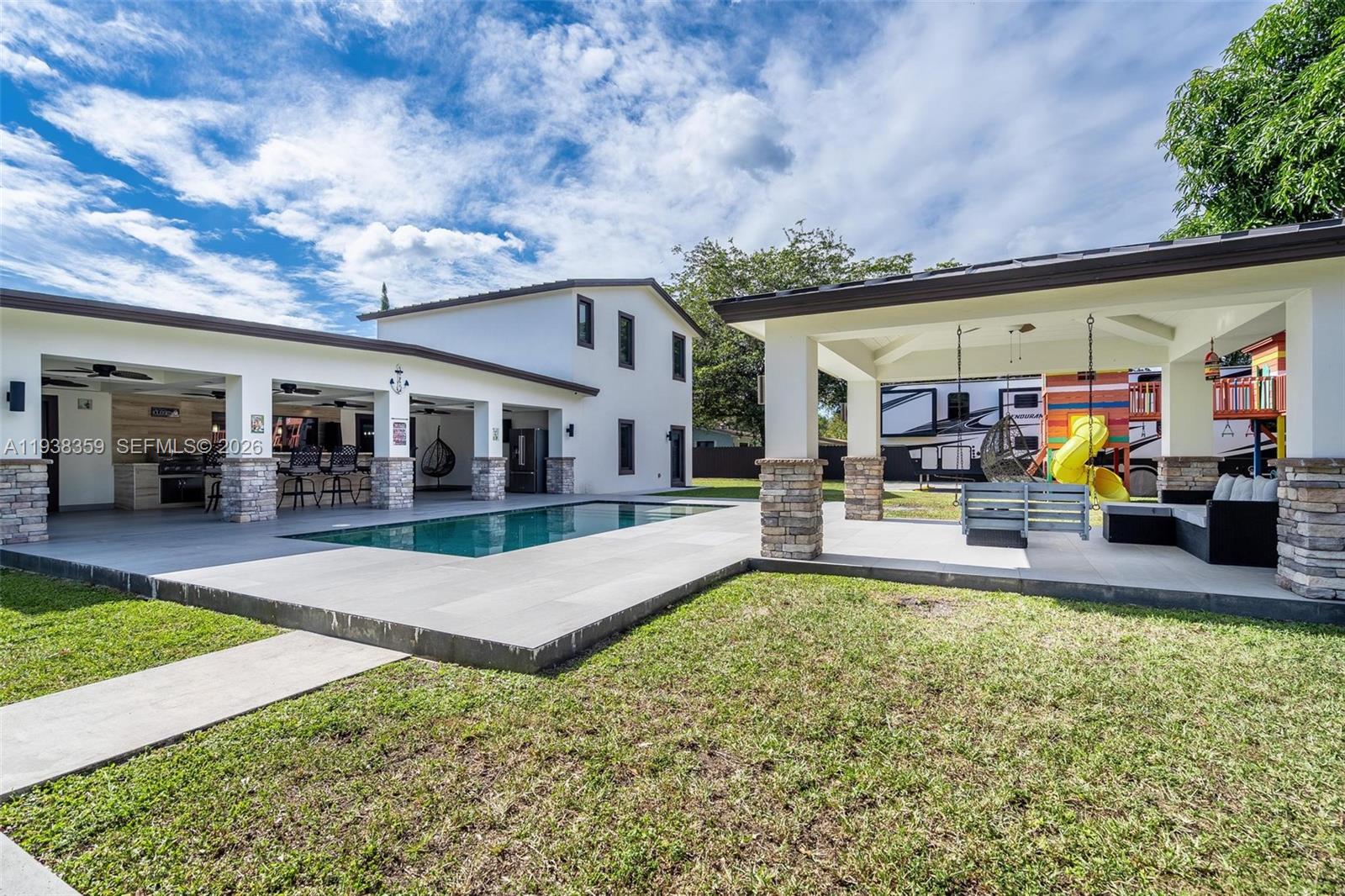 20221 Southwest 318th Street Homestead, FL 33030 - Photo 35 of 37 a view of a house with swimming pool and a yard