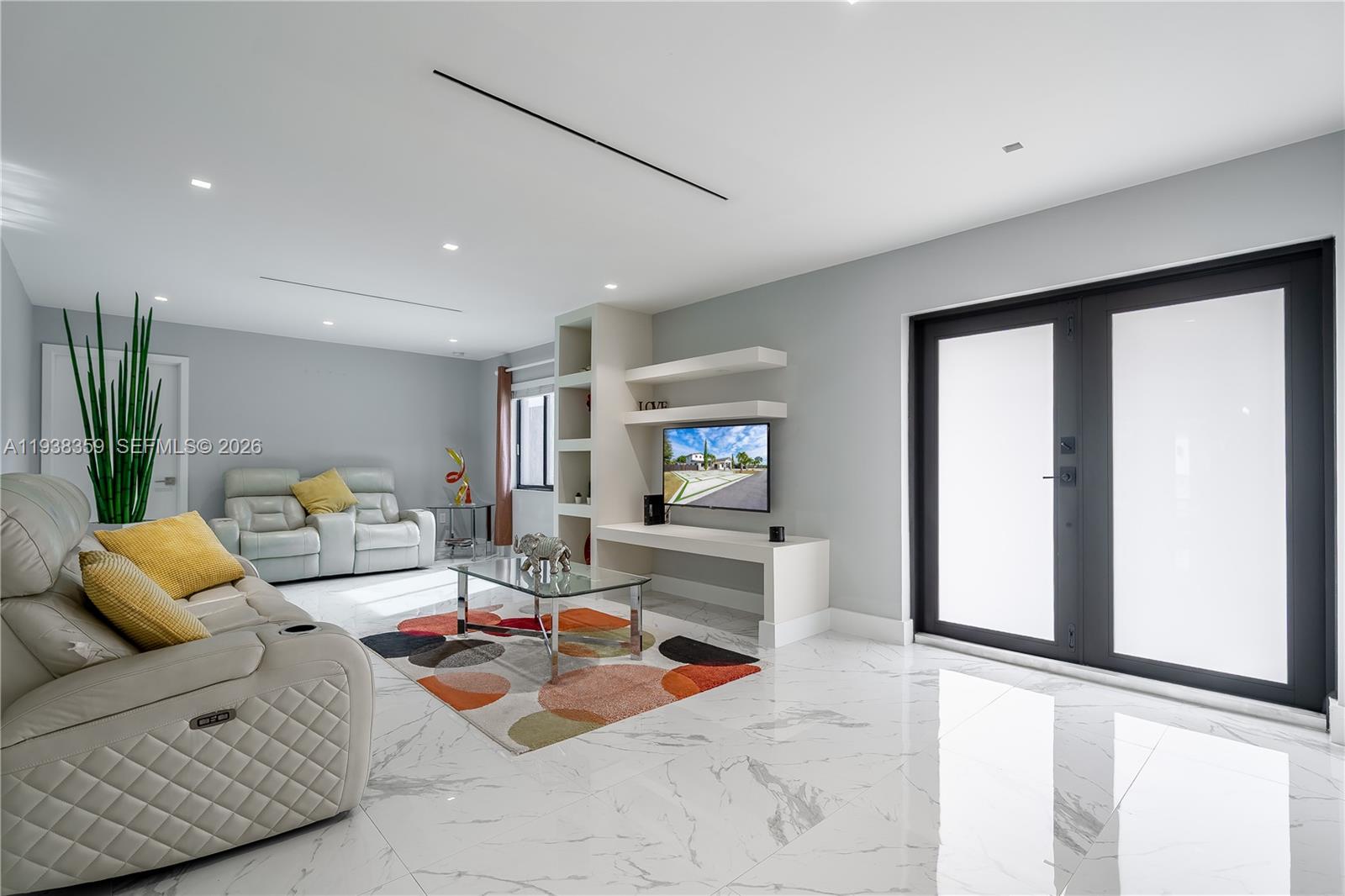 20221 Southwest 318th Street Homestead, FL 33030 - Photo 5 of 37 a living room with furniture and a flat screen tv