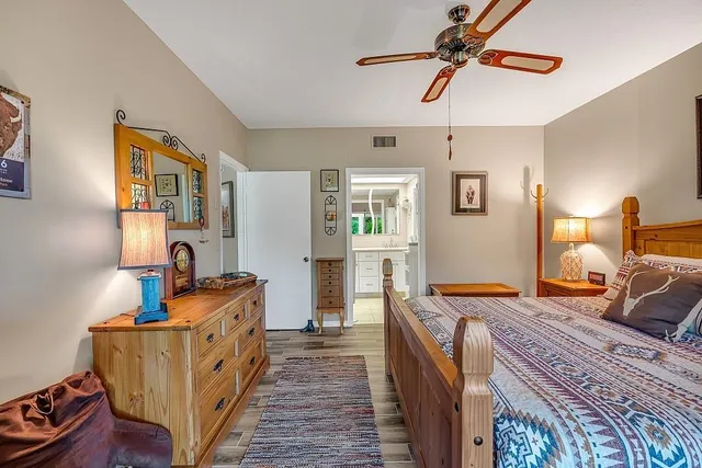 a bed room with bed and a chandelier